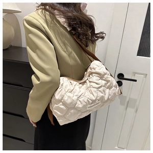 Close-up of beige quilted tote bag showing soft texture and Fashion Bag label