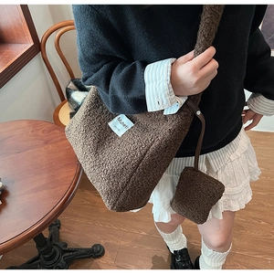 Brown teddy fleece crossbody bag with mini coin purse shown in a cozy cafe setting