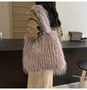 Back view of model wearing a purple faux fur tote bag with wide shoulder strap
