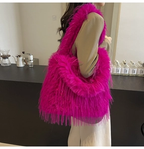 Fuchsia faux fur oversized tote bag shown on model in a stylish cafe setting