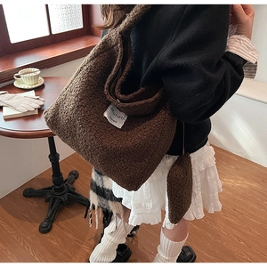 Brown fuzzy fleece tote bag with matching mini pouch shown in casual winter setting