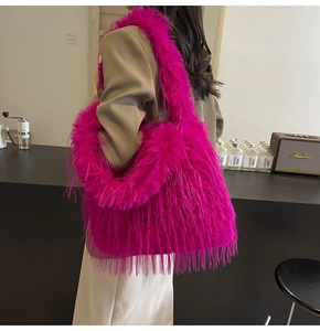 Macro shot of a vibrant hot pink faux fur tote bag showing the long plush texture and material