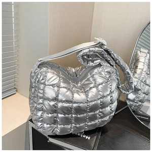 Metallic silver quilted puffer bag with cloud silhouette and large interior capacity