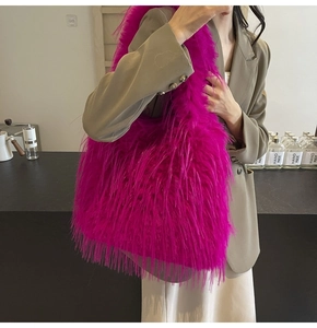 Close-up of vibrant magenta faux fur shoulder bag with soft fluffy texture and minimalist design