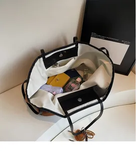 Interior view showing large capacity storage with zipper pocket in brown tote bag