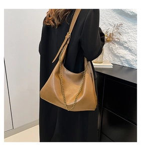Detail of tan brown hobo bag with wrinkled faux leather and golden chain strap