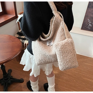 Detail of beige fleece tote bag and matching pouch showing plush texture and daily style