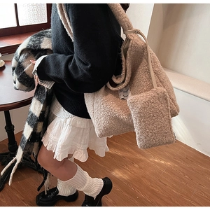 Detail of beige plush fleece tote bag and matching pouch in cozy autumn winter outfit