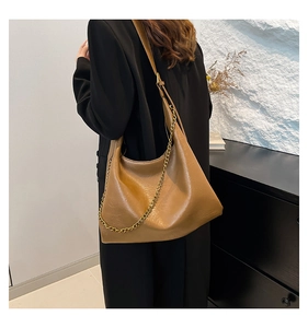 Brown PU hobo bag with gold chain strap shown on model for size and style reference