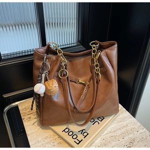 Chic brown PU leather tote bag with gold chain strap and stylish baseball charms