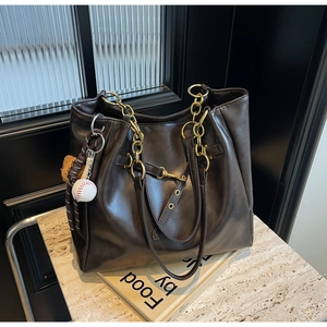 Minimalist brown PU leather tote bag with gold chain handle and baseball keychain charm