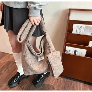 Close-up of brown faux shearling hobo bag texture and matching mini zipper pouch