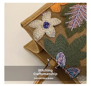 Macro shot of floral sequins embroidery and bamboo handle stitching on jute tote bag