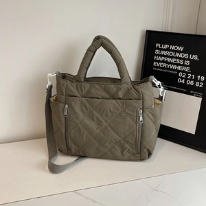 Olive green quilted nylon crossbody bag with dual front zippers and a versatile strap