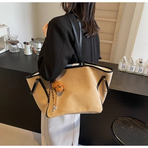 Fashionable khaki tote bag with plush dog charm and black leather trim for women