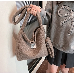 Detail of plush brown shoulder bag set with textured fleece and small hanging pouch