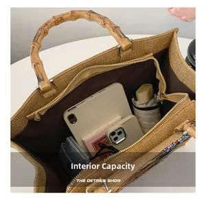 Spacious interior of linen tote bag with bamboo handles showing daily essentials and pockets