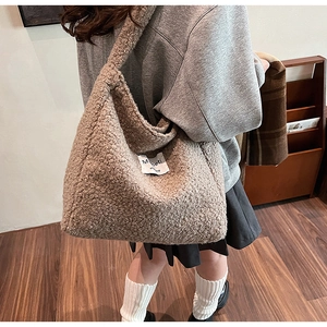 Brown fuzzy faux fur tote bag with logo patch styled on a casual college girl outfit