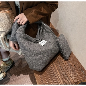 Detail of grey sherpa tote bag set featuring fuzzy texture and a matching small pouch