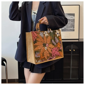 Detailed embroidery with sequins on linen tote bag with authentic bamboo handles