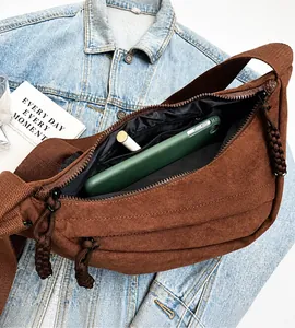 Interior view of brown canvas crossbody bag showing large capacity and zipper pocket
