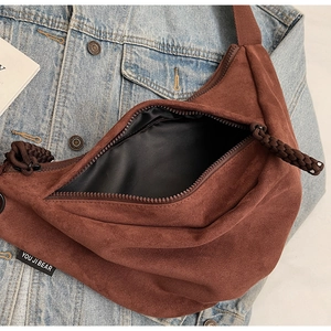 Brown faux suede crescent bag with top zipper and spacious interior for daily commute