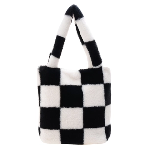 Close-up detail of plush black and white checkered tote bag with soft faux fur texture