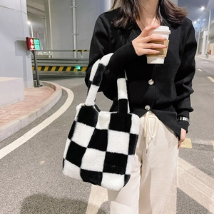 Close-up of plush black and white checkerboard tote bag with soft faux fur texture
