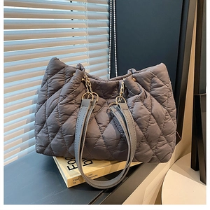 Deep grey quilted nylon tote bag with leather handles and gold chain details