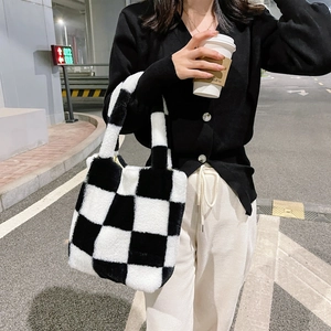 Close-up of plush black and white checkered pattern fabric on a soft winter tote bag