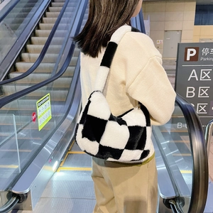 Detail of checkered plush shoulder bag showing the soft texture and black and white pattern