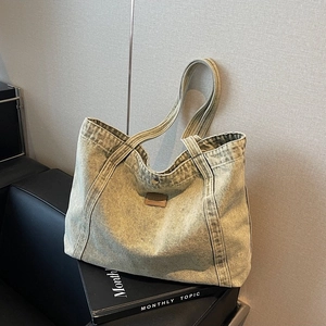 Olive green acid wash denim tote bag with brown leather logo patch for stylish women