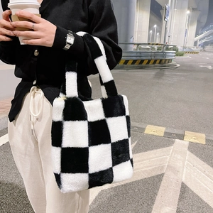 Close-up of fluffy black and white checkerboard plush tote bag with soft texture
