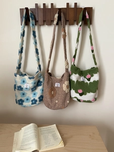 Detailed close-up of thick knitted plush crossbody bags featuring 3D floral textures