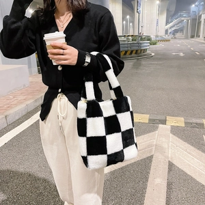 Macro shot of plush black and white checkerboard tote bag in soft faux fur material