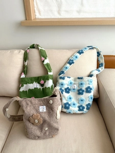 Detailed texture of plush shoulder bags with floral patterns and soft fabric