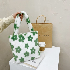 Macro shot of a plush handbag featuring green floral patterns and soft fuzzy texture