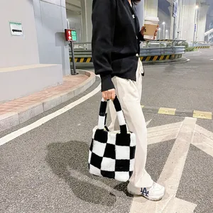 Close-up of black and white checkered plush handbag showing soft texture and street style