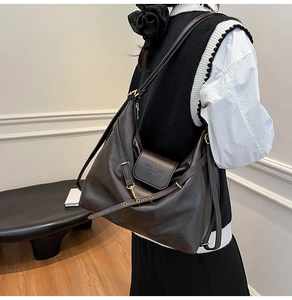Detail view of dark brown faux leather tote with gold hardware and embossed flap closure