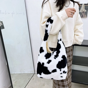 Detail view of plush cow print tote bag showing soft faux rabbit fur texture and large size