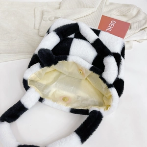 Detail view of the plush checkered tote bag interior with magnetic clasp and soft lining