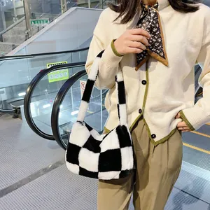 Detail showing plush black and white checkered fabric texture of the stylish handbag