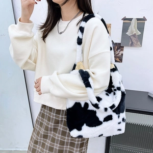 Detail of plush cow print tote bag with thick soft handles for autumn winter fashion