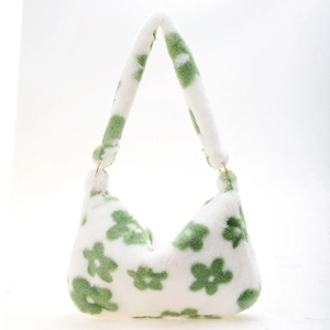 Close-up of white plush shoulder bag featuring green floral patterns and gold metal rings