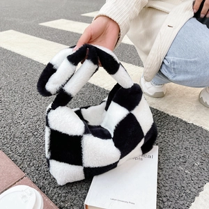 Close-up of plush black and white checkered pattern fabric on a stylish tote bag