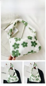 Detailed view of plush white faux fur shoulder bag with green floral patterns