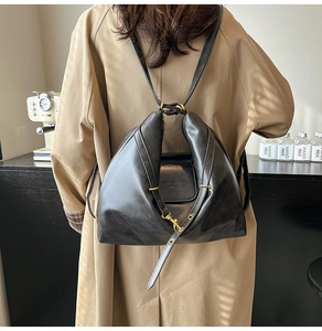 Detailed view of the black leather geometric folding backpack with vintage gold hardware
