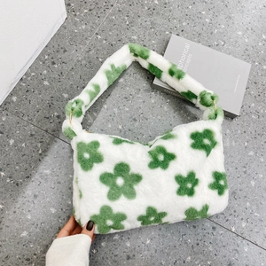 Detail of plush floral bag with green flower pattern and gold metal ring hardware
