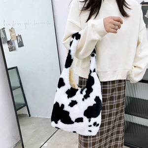 Close-up of soft cow print plush tote bag with embroidery for women and girls