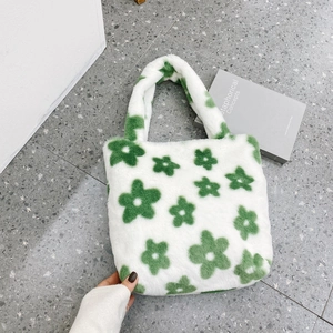 Detailed top view of soft plush tote bag with green floral pattern and fuzzy texture